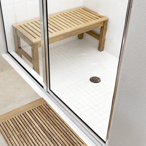 13067 Ocean teak 3 foot long backless Bench in shower on white tile beside glass shower door teak bath mat on floor