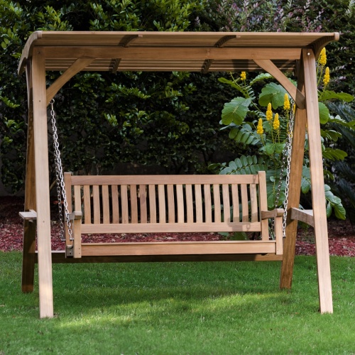 13955 veranda swinging bench on grass with trees and shrubs in background
