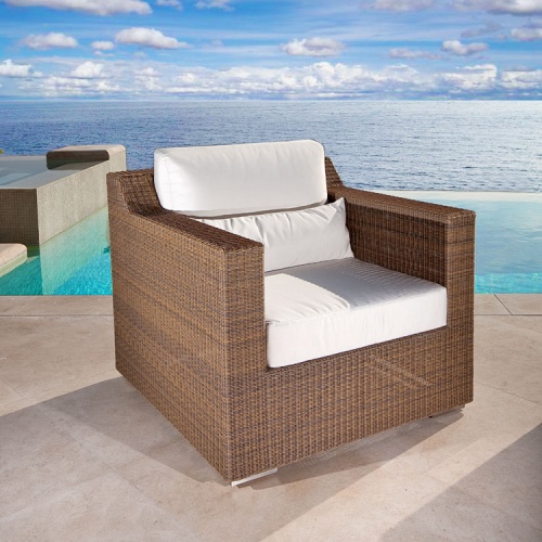 31001dp Malaga deep seat synthetic wicker armchair with cushions on tile pool deck with infinity pool and ocean in background