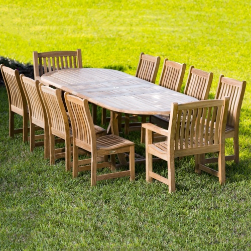 70008 Montserrat Veranda eleven piece oval dining set with teak side and armchairs on a grass field 