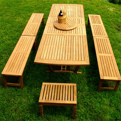 70009 Grand Veranda teak picnic table set a teak lazy susan with wine bottle and basket angle view on a grass lawn