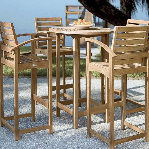 70013 Somerset teak 5 piece Bar Table Set of 4 bar stools and 36 inch round bar table on patio with bowl of oranges on table with grass area and ocean in background