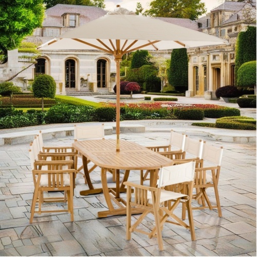 70015 Montserrat Director 9 piece teak Dining Set of Montserrat Table and 8 Director Chairs with optional opened umbrella on paver courtyard and house in background