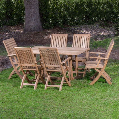 70048 Nevis Barbuda teak Dining Set on grass lawn with trees and shrubs in background
