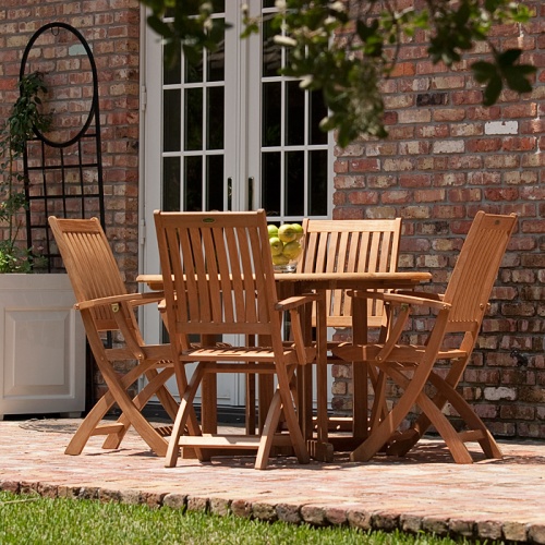 70066 Barbuda Round 5 piece Folding Dining Set on brick patio with house and french patio doors in background