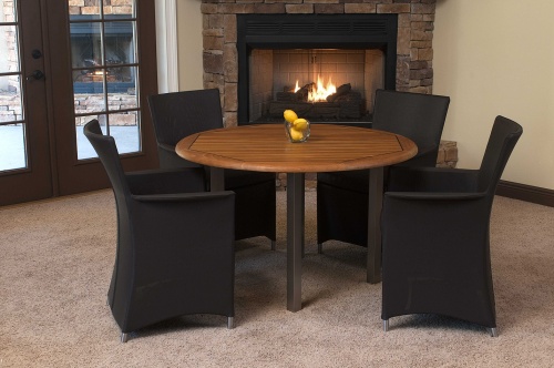 70246 Vogue Apollo Dining Set in black mesh fabric indoors on carpet with lemon centerpiece on table and a lit fireplace and patio doors in background