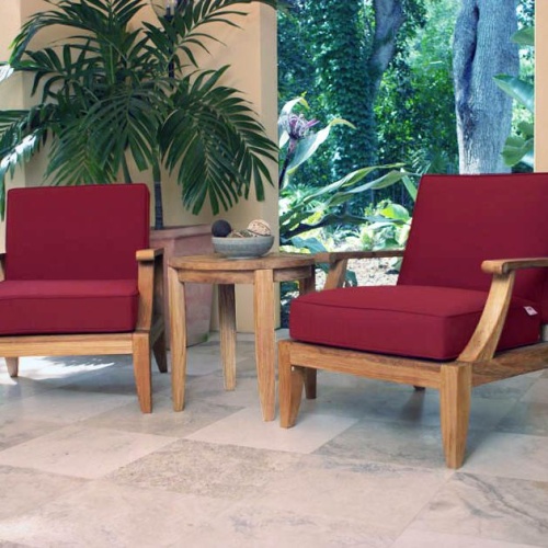 70269 Laguna three piece lounge set cushioned on travertine tiled patio with potted palm tree and landscape plants and trees in background