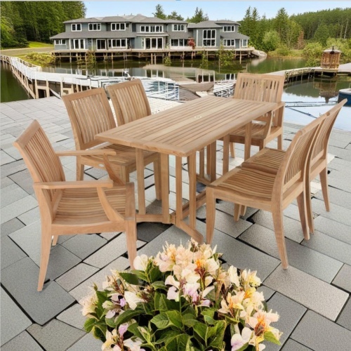 70289 Nevis Laguna teak folding dining set of Nevis Drop Leaf Dining Table and 2 Laguna Arm Chairs and 4 Side Chairs on stone patio with mansion and boat dock marina in the background