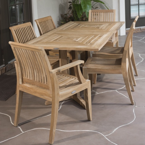 70293 Pyramid 7 piece teak Dining Set next to french doors end view on covered patio potted plants in back corner 
