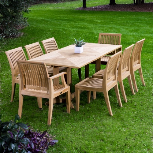 70295 Pyramid Laguna 9 piece Dining Set on grass field with trees and shrubs in background