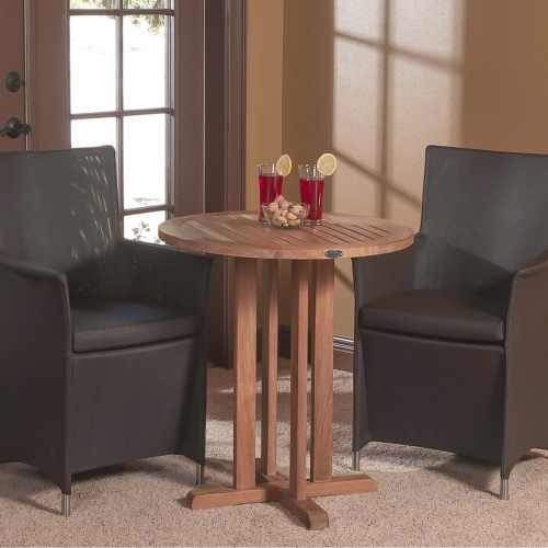 70415 Apollo 3 piece Bistro Set of 2 Tobacco Apollo Armchairs and Teak 30 inch Round Table with 2 glasses set on rug indoors with windows in back
