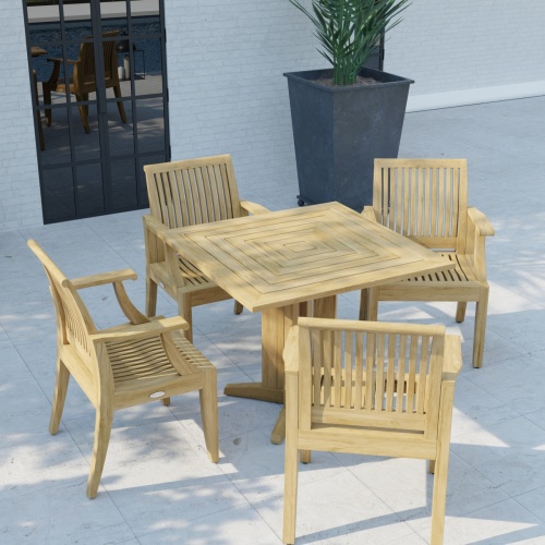 70417 Laguna Pyramid Teak 5 pc Dining Set of Pyramid 36 inch Square Table and 4 Laguna Dining Armchairs in angled view on patio with window and plant in background