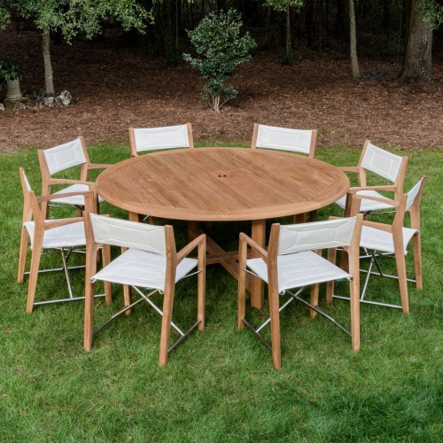 70456 Odyssey Buckingham 9 piece Dining Set on grass field with trees and brown mulch in background