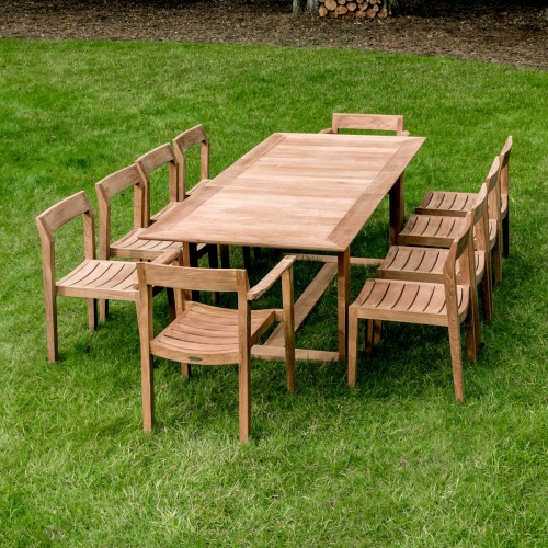 70457 Horizon eleven piece teak Dining Set outdoors angled on grass lawn
