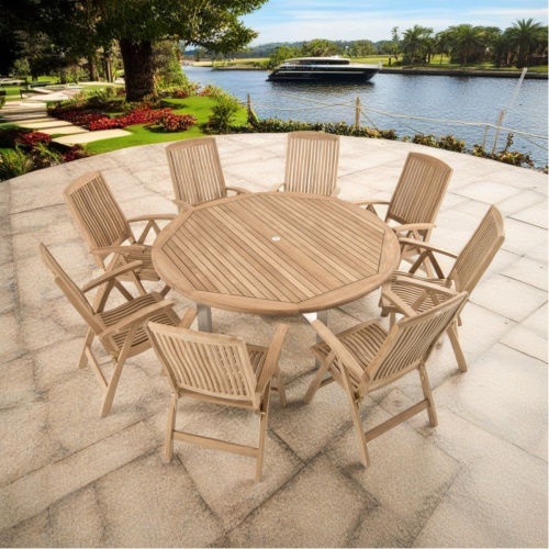 70485 Vogue reclining dining Set of Vogue Round Dining Table and 8 armchairs angled aerial view on pavers and lake in background  