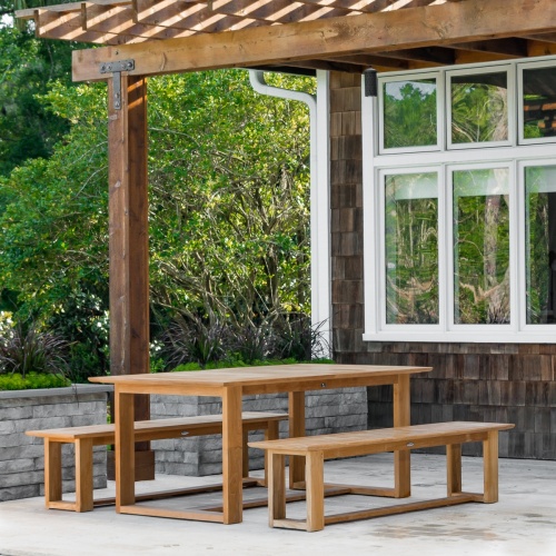 70497 Horizon teak Picnic Dining Set on concrete terrace under wood pergola with windows and lush vegetation in background