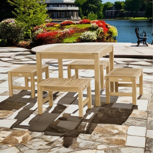 70520 Brunswick 5 piece Cafe Set of 4 teak 24 inch long stools side and 36 inch square teak table side view on paver terrace with lake and homes in the background