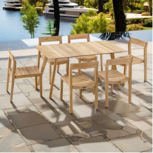 70527 Surf Horizon 7 piece teak Dining Set of 6 side chairs and teak 60 inch rectangular dining table angled view on pavers with boats and dock on lake in background