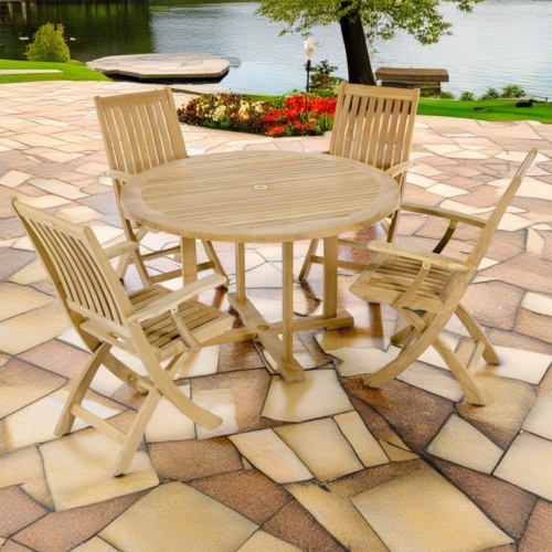 70536 Barbuda 5 piece Dining Set of 4 folding armchairs and a 48 inch diameter round dining table on patio with trees and lake in the background