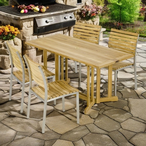 70605 Vogue Nevis Dining Set of a Nevis 60 inch rectangular folding table side angled end view on patio with BBQ and trees in  background