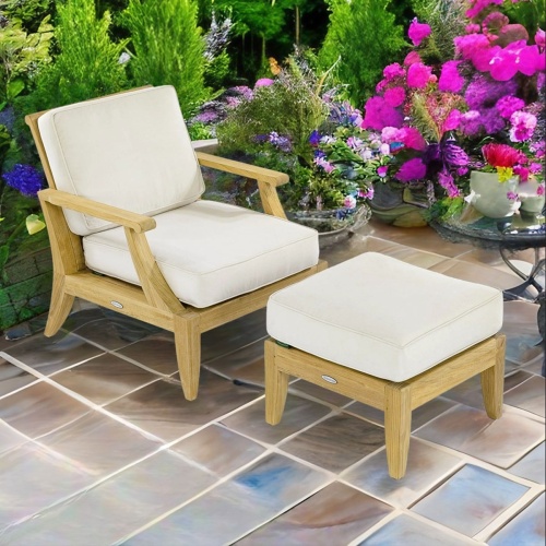 70707 Laguna deep seating teak chair and Ottoman with Canvas color cushions angled on a tiled patio with landscape shrubs and flowers in background 