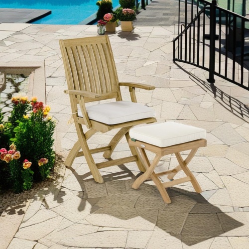 70799 Barbuda teak Chair and Ottoman with optional canvas colored cushions set angled on paver deck with pool in background 
