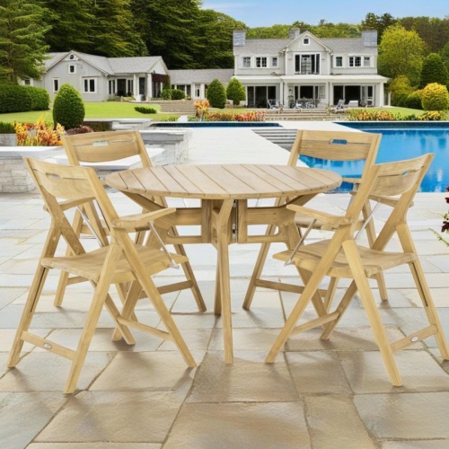 70804 Surf Yacht  5 pc 42 inch round Folding Dining Set of a Surf 42 inch round dining table and 4 dining chairs on patio with pool and house with landscape plants and plants in background