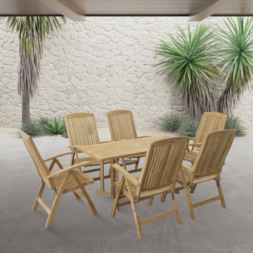 70903 Nevis Barbuda 7 piece Recliner Dining Set of 6 Barbuda dining chairs and Nevis teak rectangular table on paver patio with stone wall and plants in background