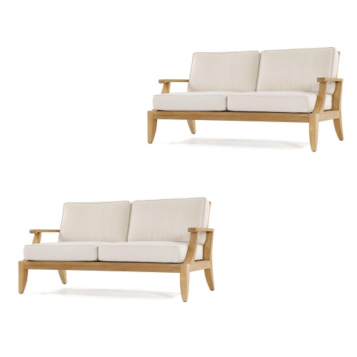 70915 Laguna Sofa Set of 2 Laguna teak loveseats with canvas colored cushions angled towards each other on patio with trees and shrubs and lake in background