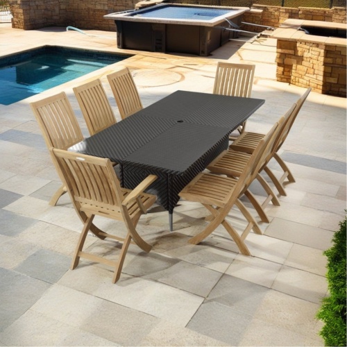 70923 Valencia Barbuda 9 piece Dining Set of Valencia rectangular wicker Table and 6 Barbuda Side Chairs and  6 Arm Chairs angled view on patio with pool and jacuzzi and firepit in background    
