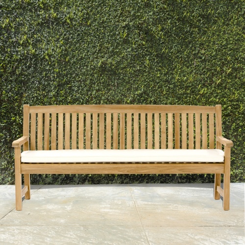 13883 6 foot Veranda Teak Bench on concrete patio with bushes in background