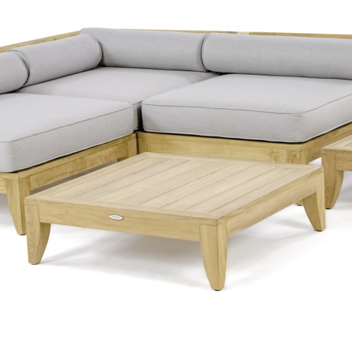 14315 aman dais teak coffee table angled shown with the aman dais sectional set on a white background