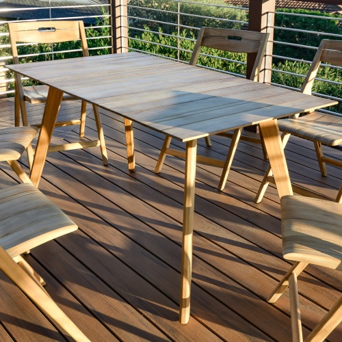 15917 Surf Teak Dining Table side view on deck overlooking field
