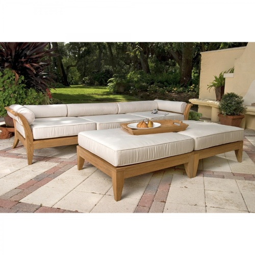  16767 aman dais sectional set ottoman with teak tray and plated pears on stone patio with trees in background
