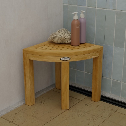 18818 Pacifica Corner Spa Stool in shower showing a loofah and 2 bottles of shampoo on top in a front view