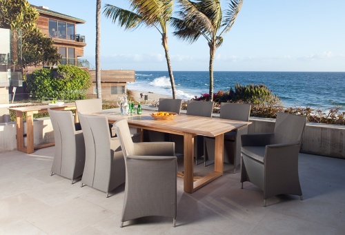 29003S Apollo Armchair blemished with wax stains on chair arm with Apollo Dining Set on concrete terrace overlooking ocean and blue sky with palm trees and house in background