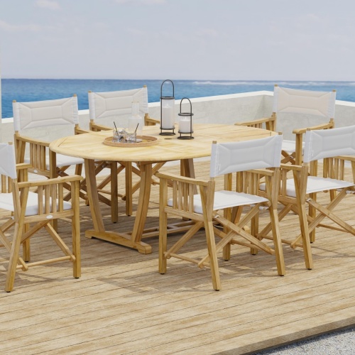 70079 Martinique Director Chair 7 piece Oval Dining Set side view on outdoor terrace with ocean and blue sky in background