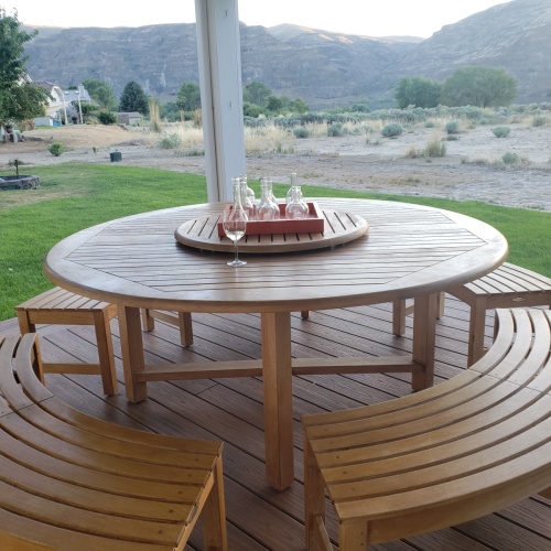 70090 Buckingham Picnic Dining Set showing teak lazy susan with Wine Glasses in center sitting on a wooden deck overlooking mountains and field