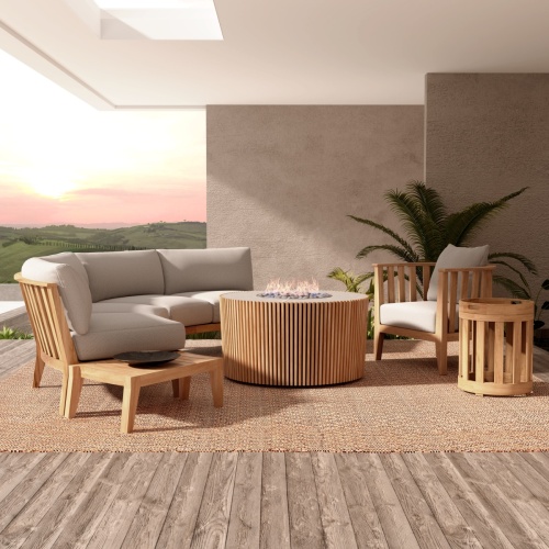 70181 Kafelonia 7 pc Lounge Sofa Set with the Agora Fire Table on area rug on wood floor on a covered patio with potted plants against wall and hillside view in background