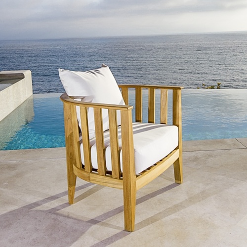 70257 kafelonia teak chair with cushions on patio with pool and ocean in background