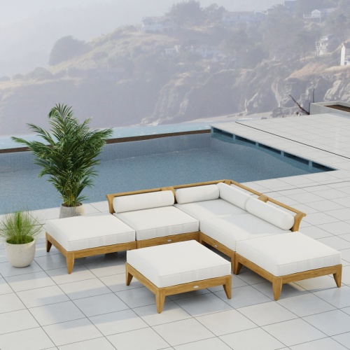 70283 Aman Dais 6 pc Daybed Sectional Set in angled aerial view on patio next to potted plant with pool and ocean and hillside view in background