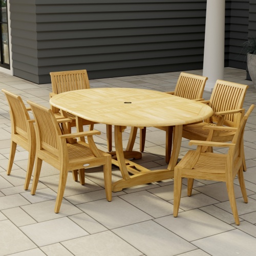 70306 Martinique 7 pc Teak Dining Set of Martinique Teak Oval Extending Dining Table and 6 Laguna DIning Chairs angled end view on stone patio with a house in the background