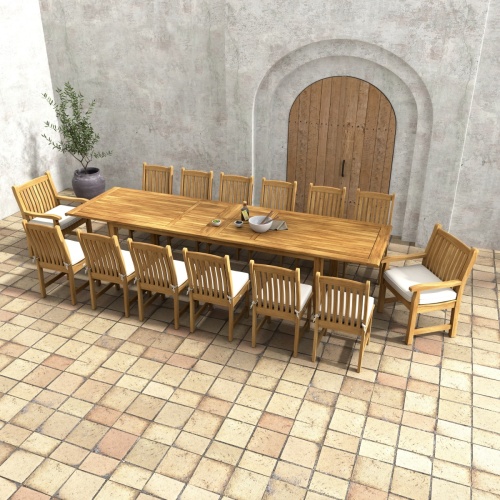 70361 Grand Laguna 15 piece teak Dining Set of 12 teak dining chairs with optonal cushions around a teak rectangular extendable dining table angled aerial view on patio and a potted tree in background 