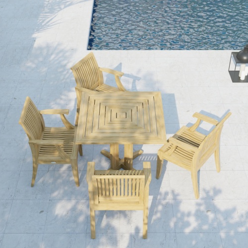 70417 Laguna Pyramid Teak 5 pc Dining Set of Pyramid 36 inch Square Table and 4 Laguna Dining Armchairs in angled aerial view on patio next to pool in background