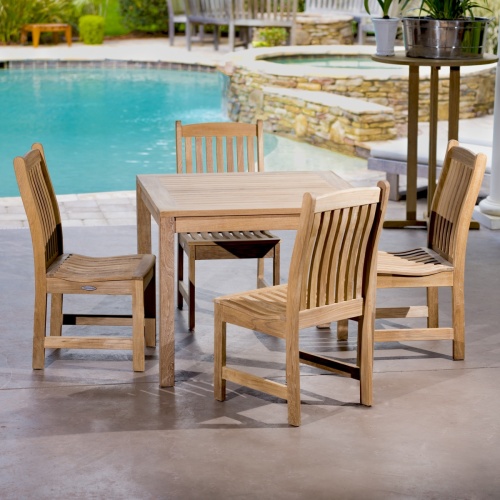 70424 Veranda teak 5 piece square Bistro Set of 4 teak side chairs and 36 inch square dining table on concrete patio with pool in background