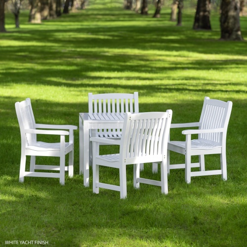 70425 Veranda 5 piece Square Teak Dining Set shown in poly white finish on grass field and tree lined background