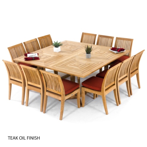 70435 Pyramid 14 piece teak Dining Set with teak oil finish and optional custom colored cushions two green plants four plates and cloth napkins angled on white background