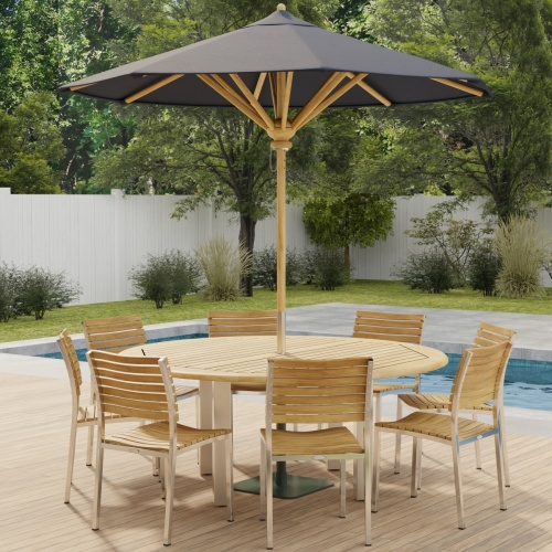 70444 Vogue Teak Dining Set for 8 with optional umbrella side angled view on outdoor deck  next to a pool with fence and plants and trees in background 