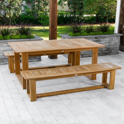 70497 Horizon teak Picnic Dining Set on outdoor deck with paver planters with landscape plants with grass and shrubs in background