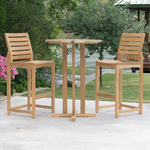 70499 Somerset 3 piece Bistro Bar Set on concrete patio with lake trees and boat dock in background